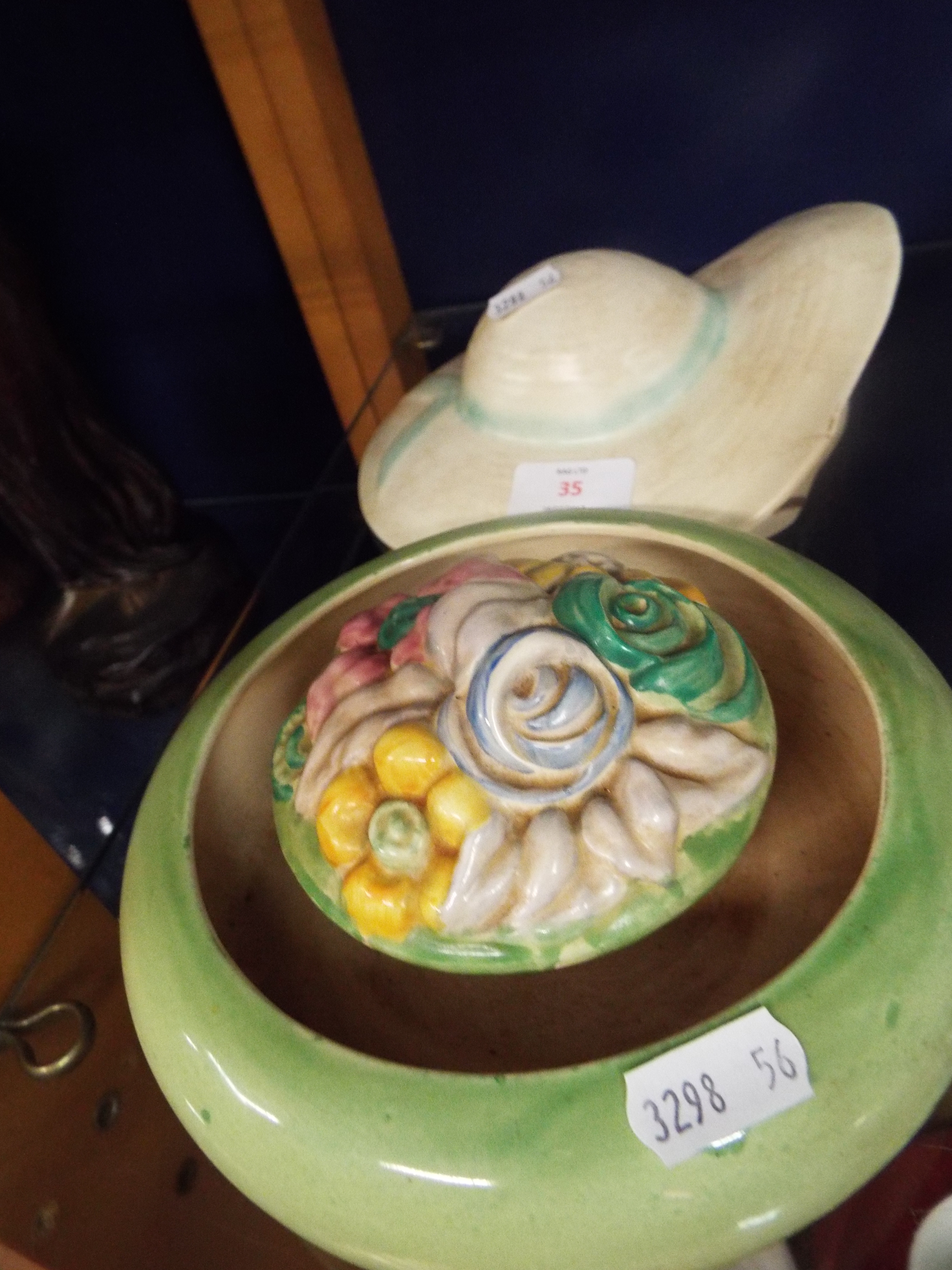 A Clarice Cliff circular floral decorated posy vase together with a Clarice Cliff style hat wall