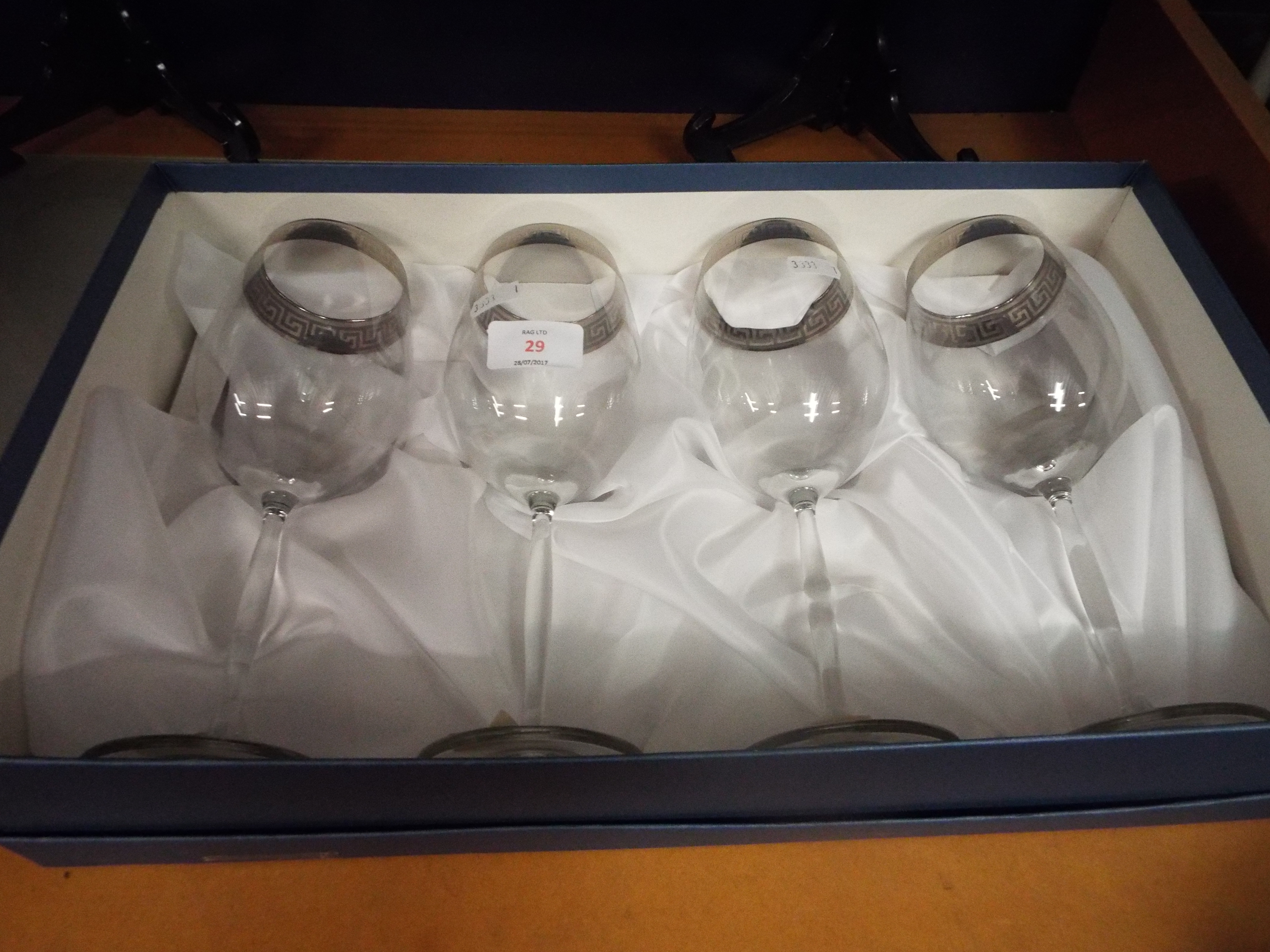 A boxed set of four Italian wine glasses,