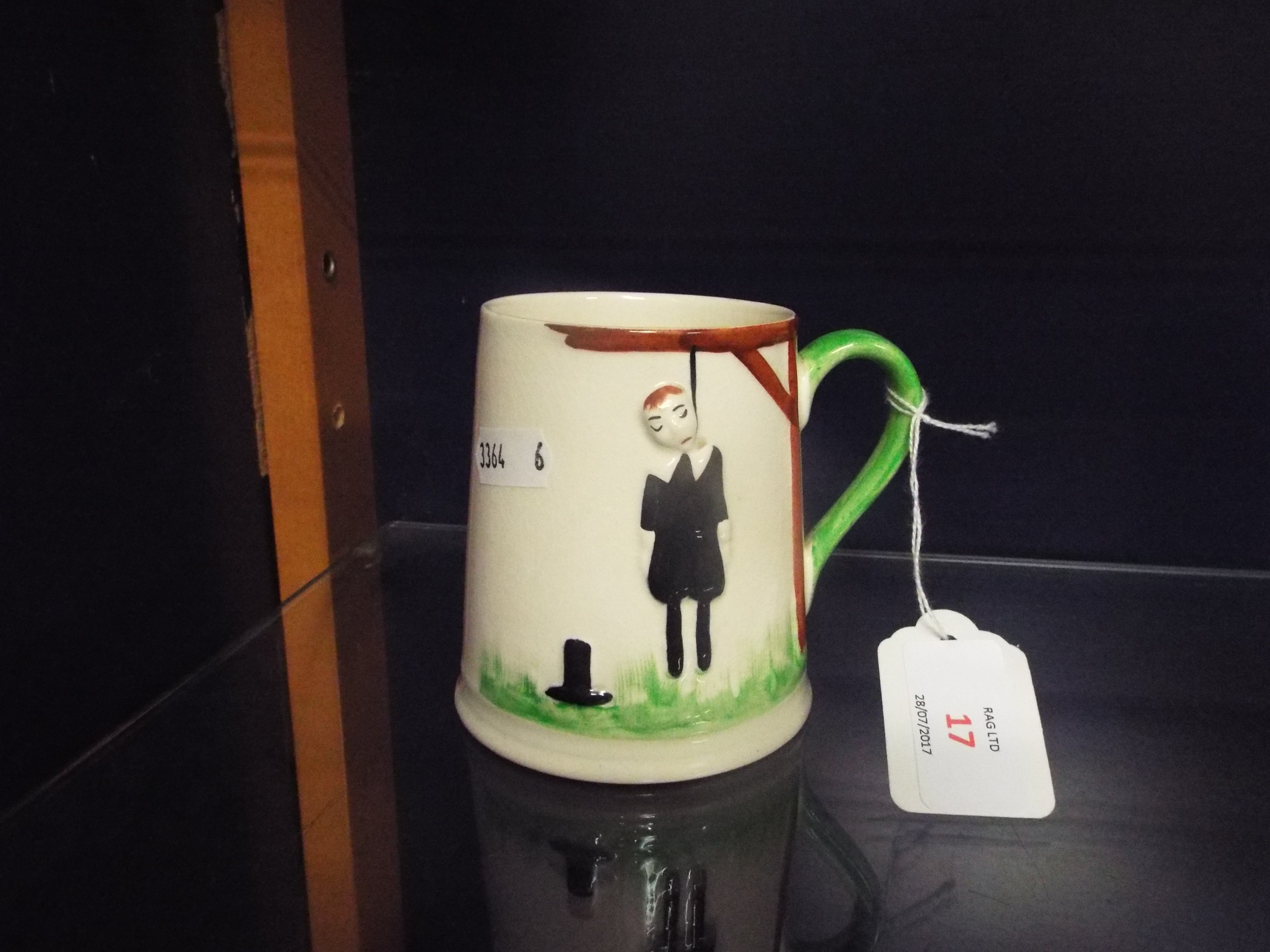 A 1930s Carlton ware 'Hangman' tankard with embossed hanging pilgrim to front and verse to back and