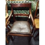 An early 19thC mahogany elbow chair with drop-in seat