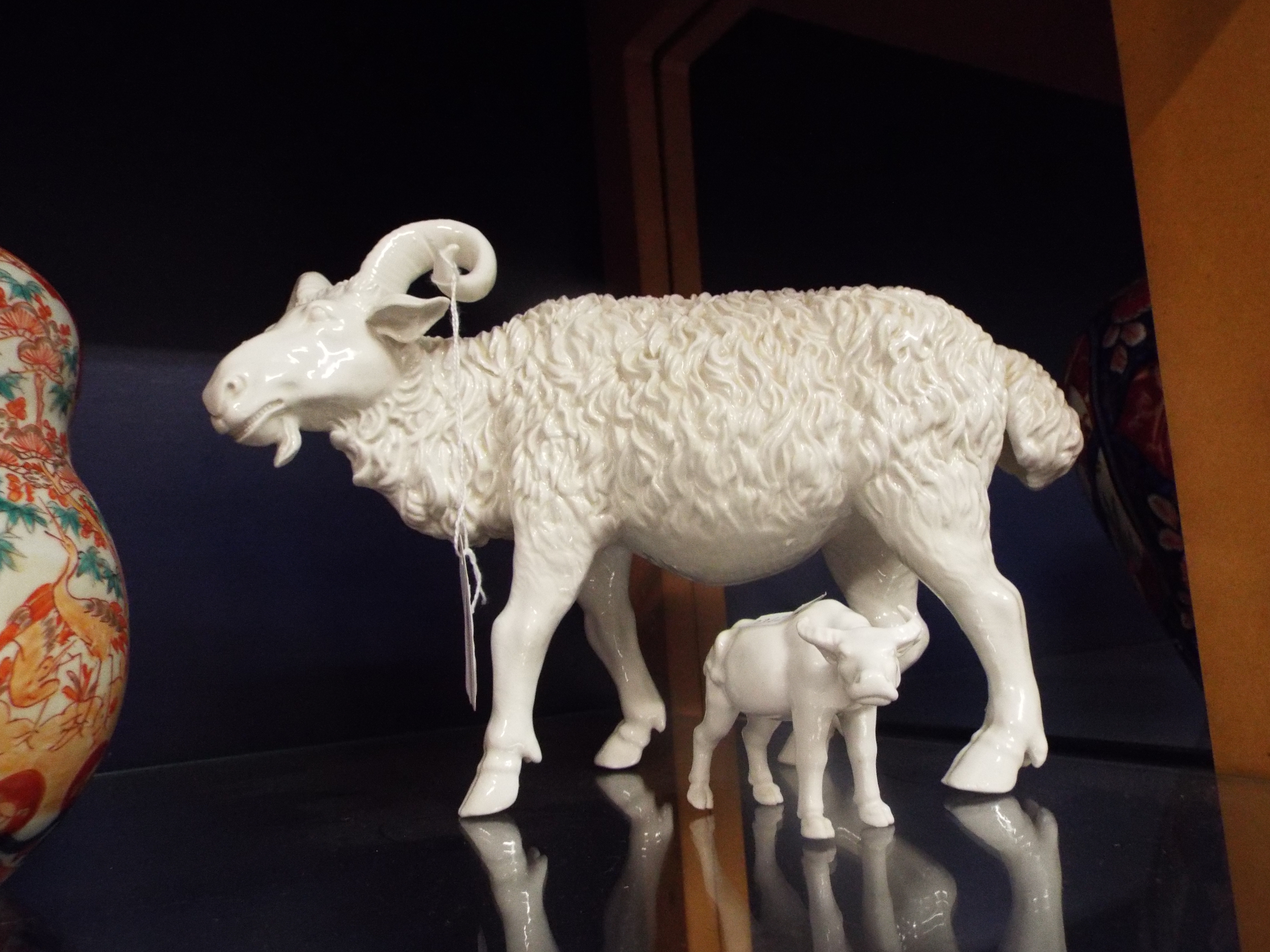 An early 20thC blanc de chine goat (possibly Chinese) together with a blanc de chine water buffalo