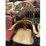 A beech comb back Windsor chair raised on turned supports