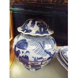 A large Chinese blue and white ginger jar decorated with figures, buildings and ponds,