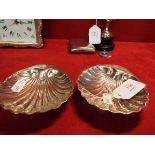 A pair of early 20thC silver scallop shaped dishes,