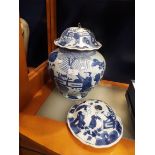 A large Chinese blue and white ginger jar decorated with figures, buildings and ponds,