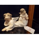 Two Lladro figurines of angels, one praying the other resting the other reclining,