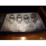 A boxed set of four Italian wine glasses,