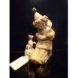 A Lladro figurine of a musical clown with dog,