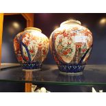 A pair of Oriental lidded ginger jars having mainly blue and red decoration,