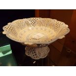 A very fine porcelain lattice work pedestal bowl of arch form with central floral band