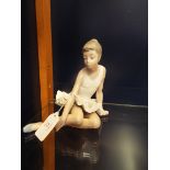 A Nao ballerina in seated position,