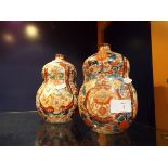 A pair of early 20thC Oriental double gourd vases having bird and foliate decoration