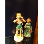 A Goebel figure of a girl with chamberstick and another of a girl with harmonica