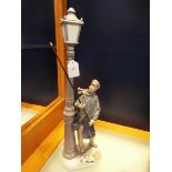 A Lladro figuring 'Lamplighter',