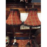 A pair of ornate faux iron table lamps with moulded acanthus bases and tapestry style shade