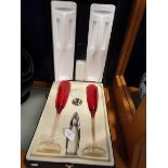 A pair of Brandani ruby red champagne flutes and accessories,