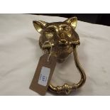 A brass door knocker in the form of a foxes head