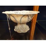 A very fine porcelain lattice work pedestal bowl of arch form with central floral band