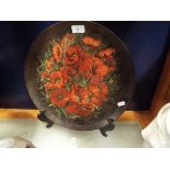 A Victorian hand painted charger decorated with sprays of poppies,