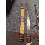 An African sword housed in a leather scabbard