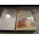 An album containing assorted telephone cards and postage