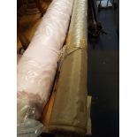A roll of pink cotton fabric and a roll of brown silk type fabric