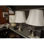 A pair of brushed steel and faux glass table lamps and shades together with one other