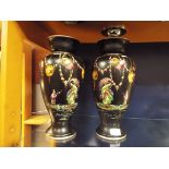 A pair of Japanese black ground vases having pictorial pattern depicting Geisha girl and floral