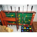 A table style bar football game together with two sets of petanque balls