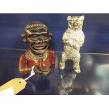 A cast iron 'The Jolly Negro' money box together with a silver plated money box in the form of a