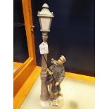 A Lladro figuring 'Lamplighter',