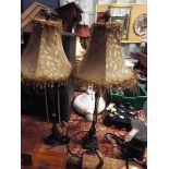 A pair of ornate faux iron marbled table lamps with floral lustre shades