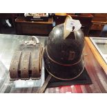 A late 19thC Swiss fire helmet in original paint with brass comb, leather liner and chin guard,