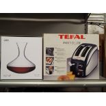 A boxed Tefal Avanti Deluxe toaster together with an LSA glass wine decanter
