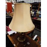 A large brass table lamp and shade