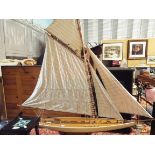 A model pond yacht resting on stand 41" long x 46" high