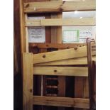 A pine double bed with spindle back headboard