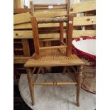 An Edwardian walnut side chair with cane seat together with a small pine stool