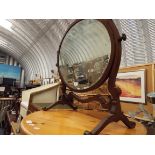 A late Victorian chequer strung walnut swing mirror raised on scrolling supports