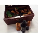 A vintage chess set housed in a leather jewellery box