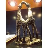 A carved stone figural group of giraffes