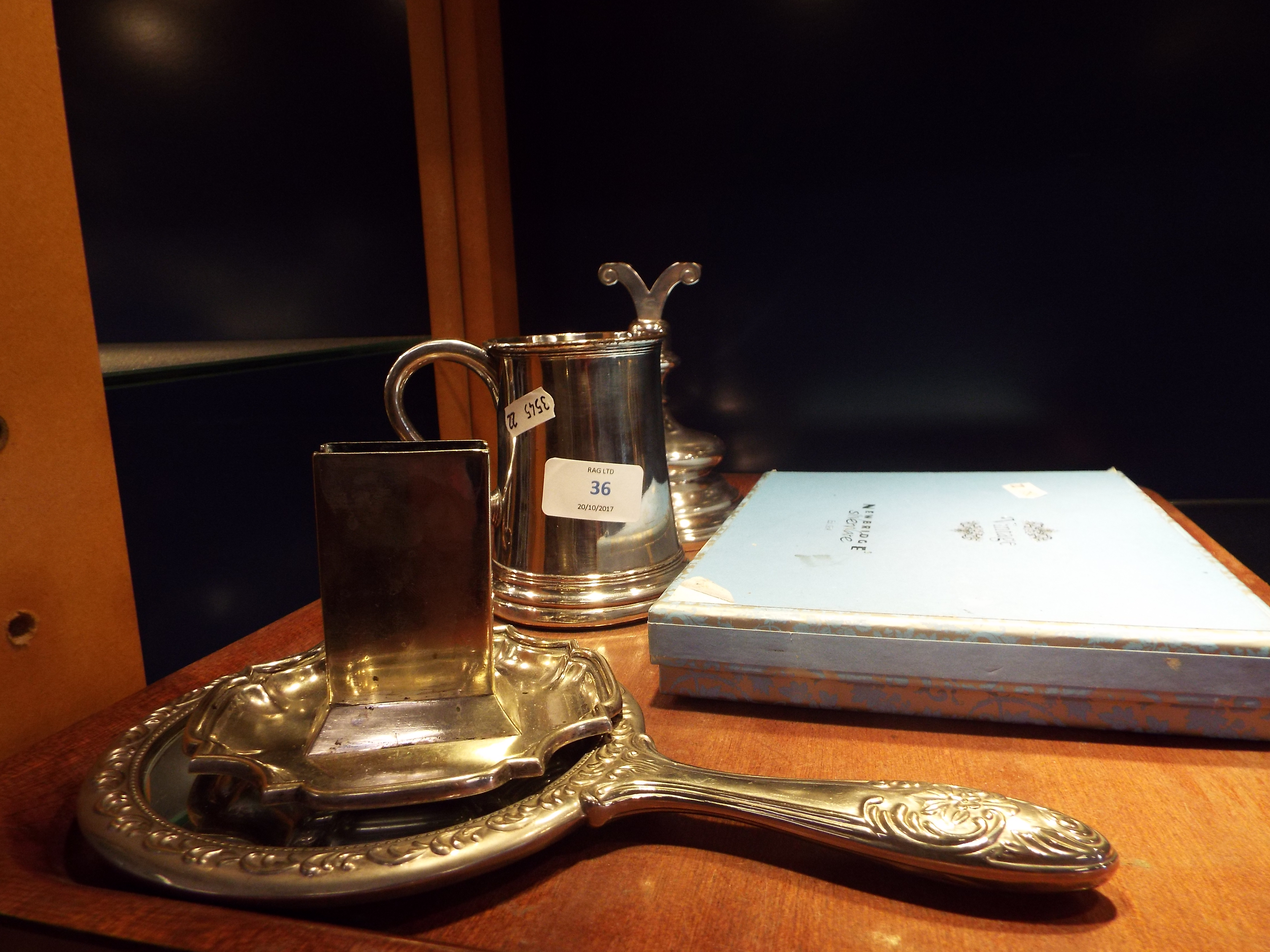 A small selection of silver plated ware to include a boxed set of menu holders, tankard, mirror,