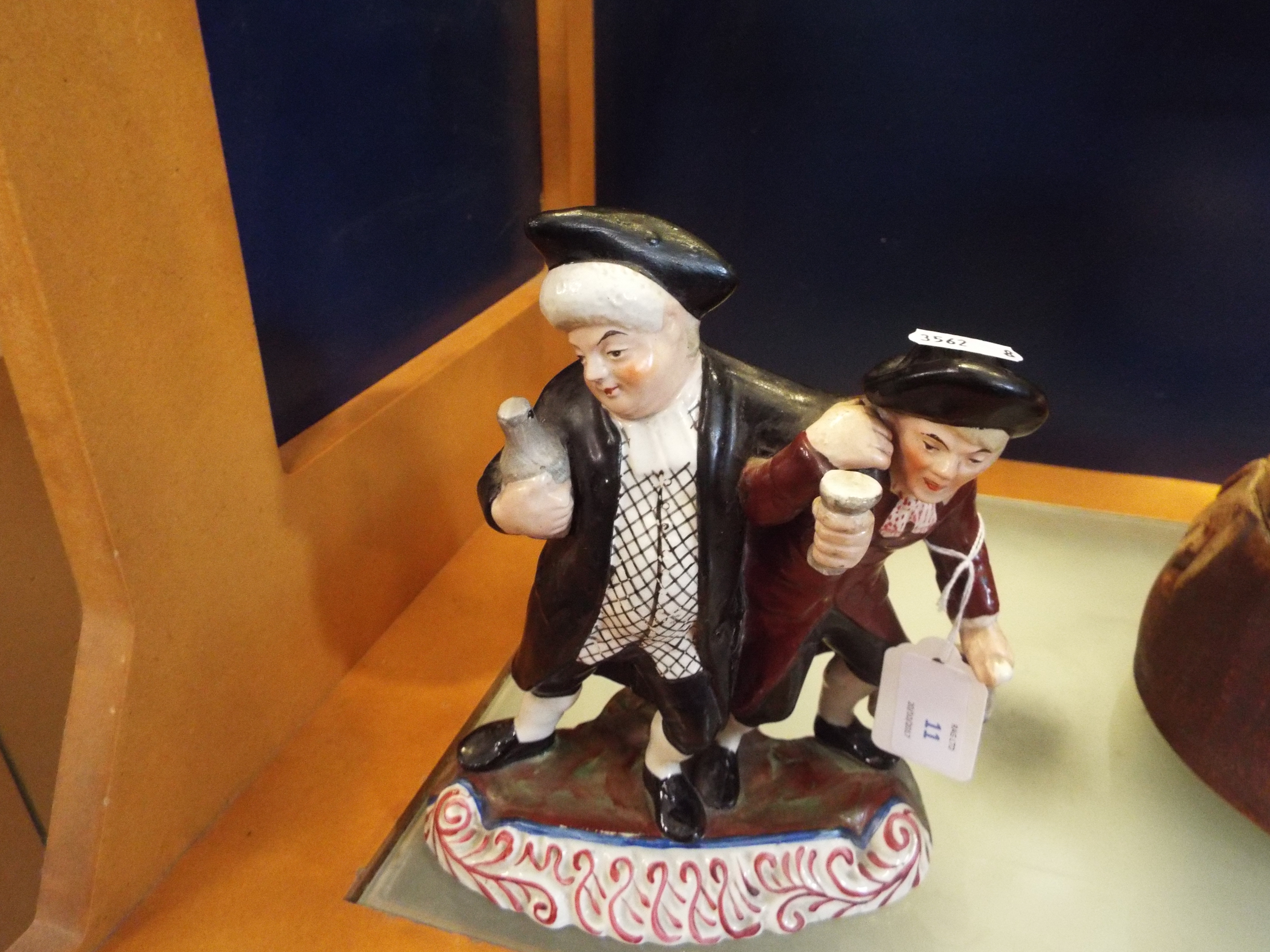 A Staffordshire style figurine of two gentlemen drinking