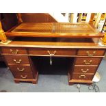 A mahogany desk fitted with three friezed drawers above a pair of three drawer pedestals