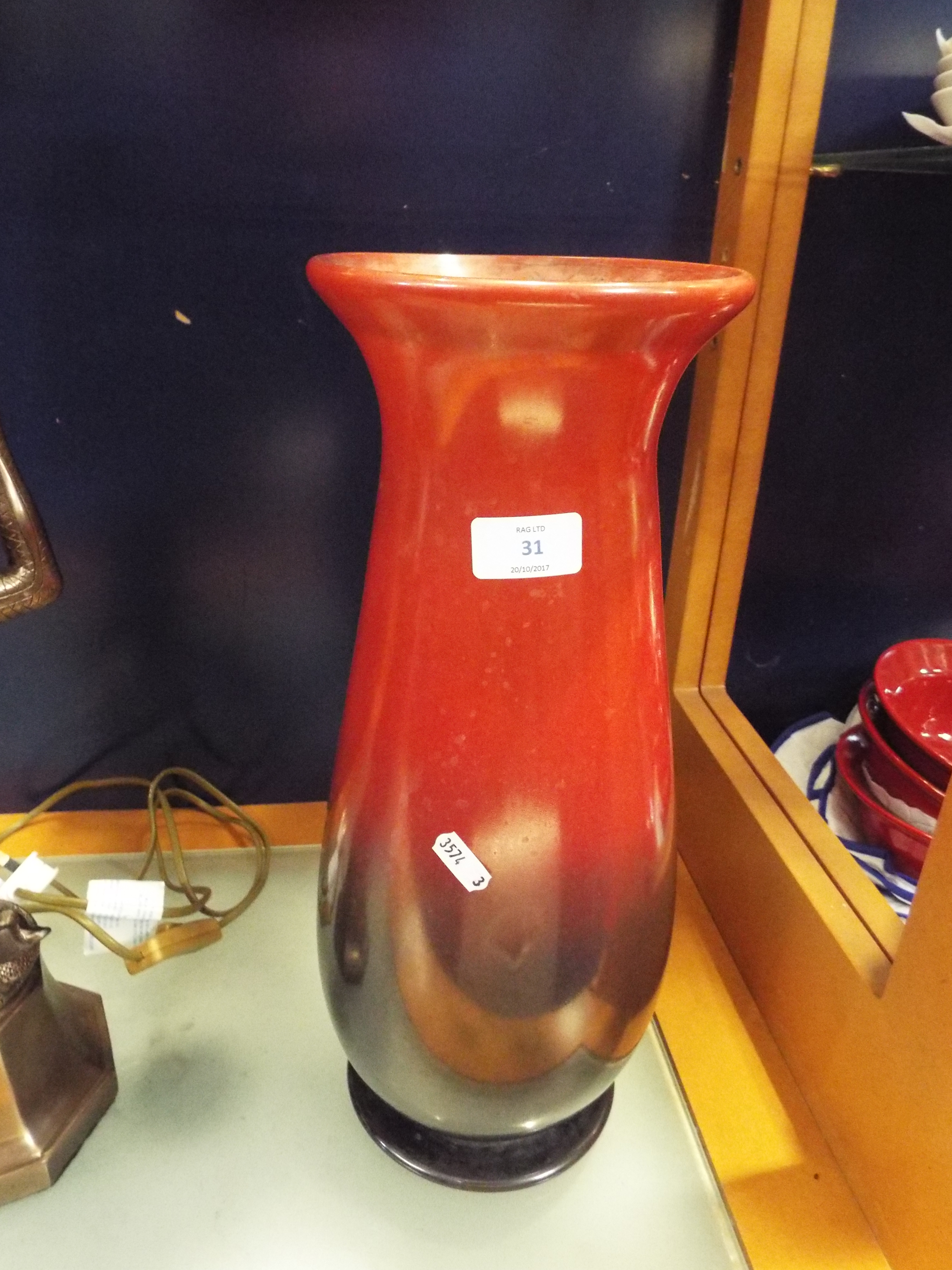 A large glass vase with painted black and red ombre effect lustre