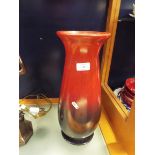 A large glass vase with painted black and red ombre effect lustre