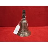 A silver bell with religious inscriptions