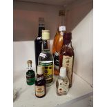 A mixed selection of alcoholic beverages to include a bottle of Black & White whisky,