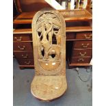 A carved Cameroon birthing chair