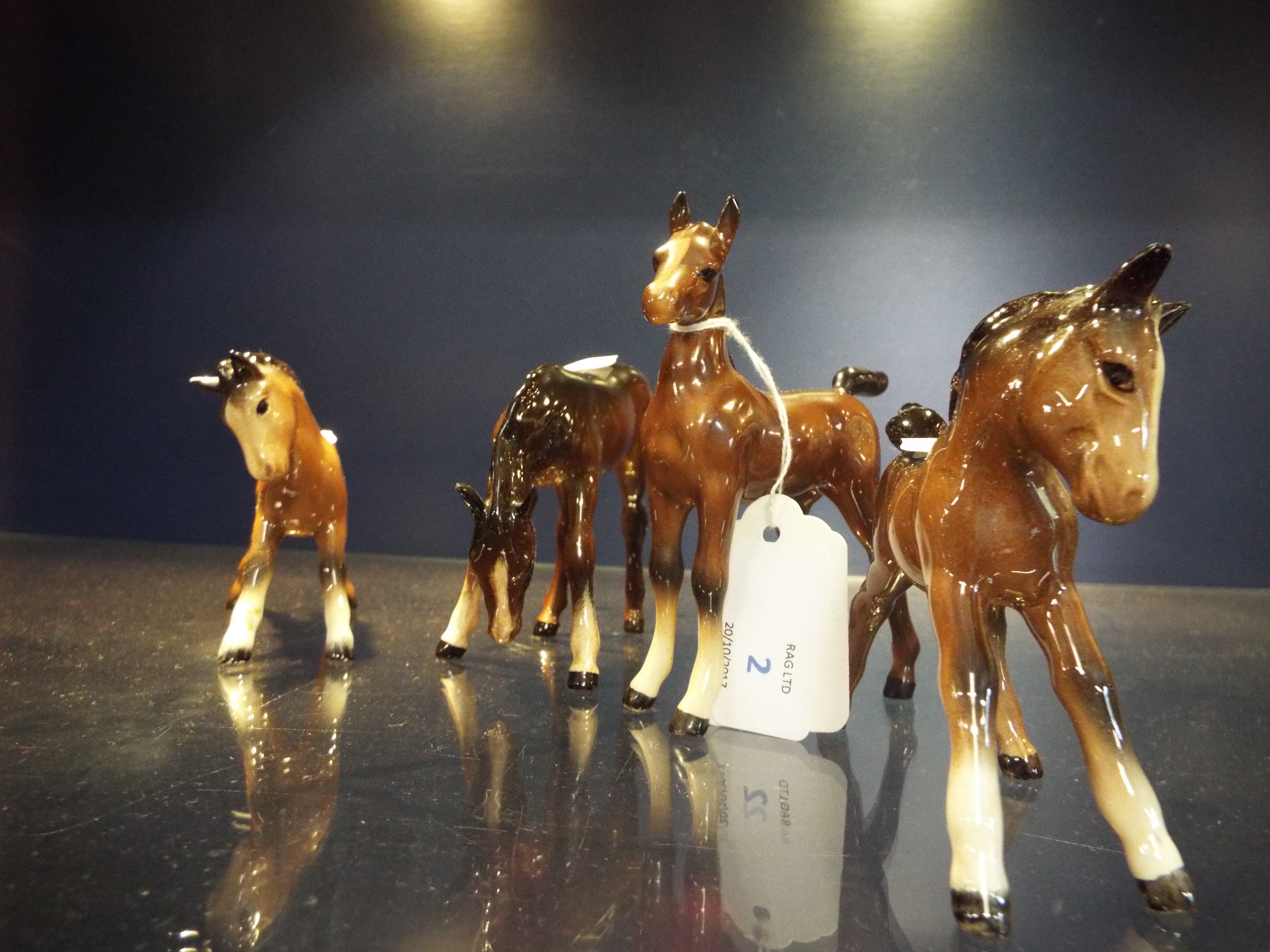A group of four assorted Beswick ponies